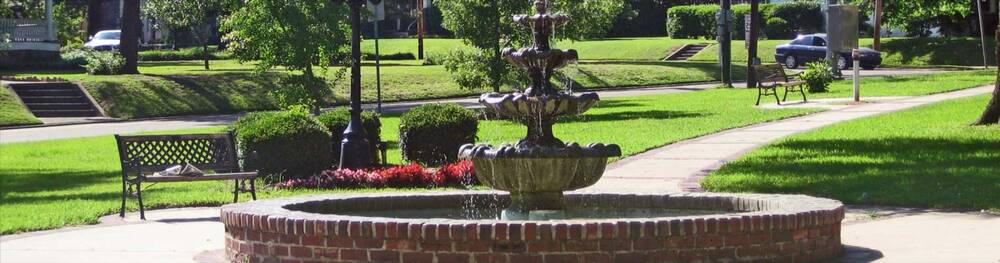 Water fountain and benches in park
